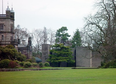 View across lawns. The eventual tonal match of the paving slabs and stone can be seen.